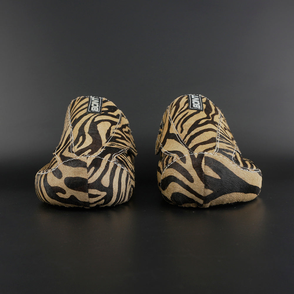 Skater wearing Envy Cow Zebra Print Style Roller Skates in motion