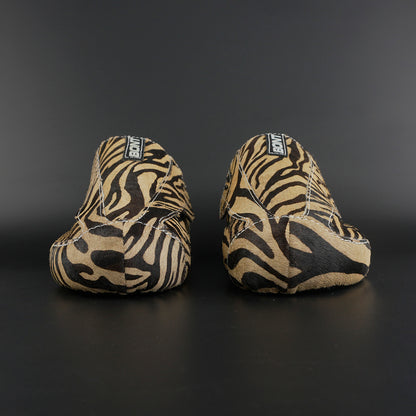 Skater wearing Envy Cow Zebra Print Style Roller Skates in motion