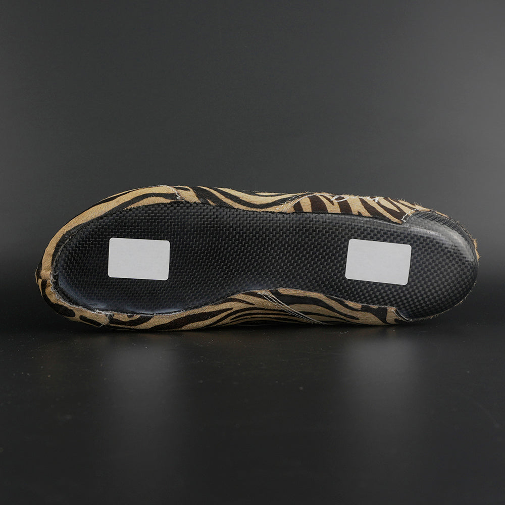 Skater wearing Envy Cow Zebra Print Style Roller Skates in motion